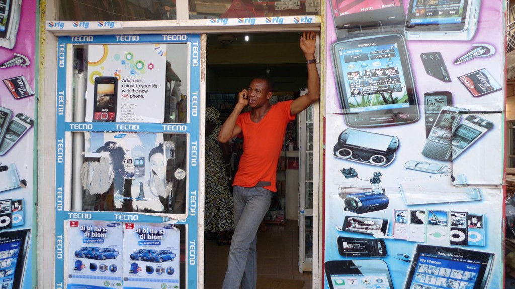 Man stands in doorway of mobile phone shop