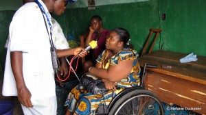 Journalist interviews a woman in a wheelchair