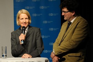 Gerda Meuer holds a microphone while Michael Windfuhr stands next to her