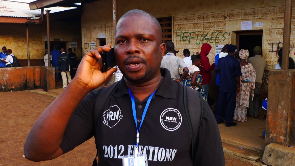 IRN reporter holds a telephone to his ear