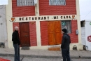 Two men standing in front of closed restaurant
